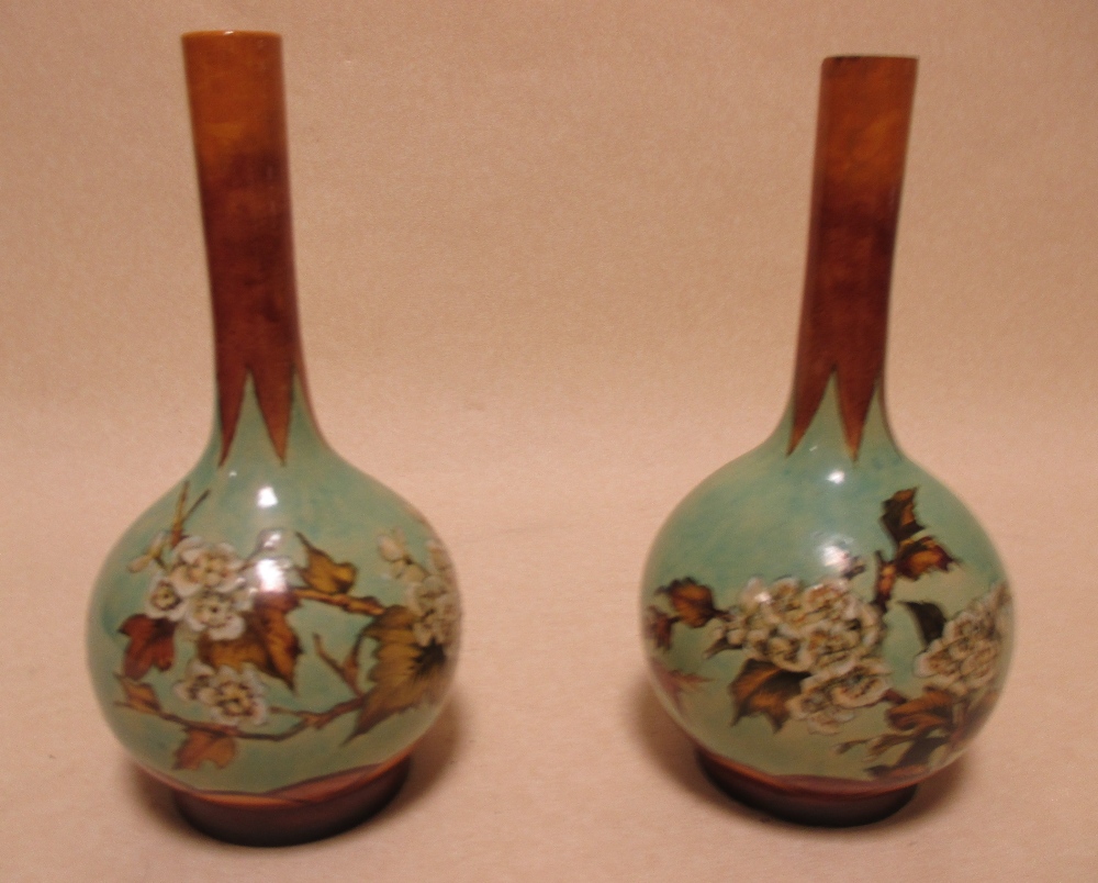 A pair of Royal Doulton faience bottle vases, 20cm high