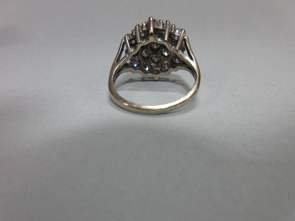 A diamond cluster ring set in 18ct gold, closely set with nineteen round brilliant cut diamonds in a - Image 4 of 6