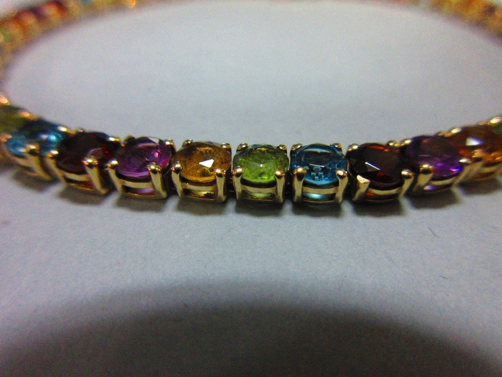 A multi-coloured gem set line bracelet, the uniform round cut gems, to include garnet, blue topaz, - Image 2 of 6
