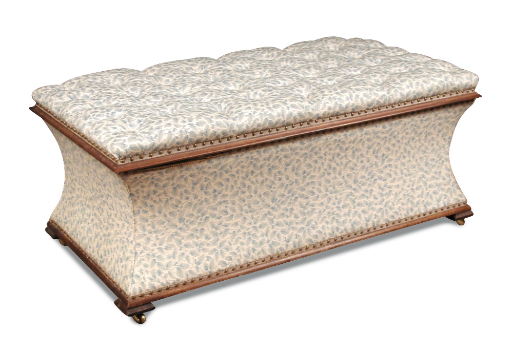 An upholstered ottoman by Geoffrey Bennison, buttoned striped fabric with hinged cover on brass