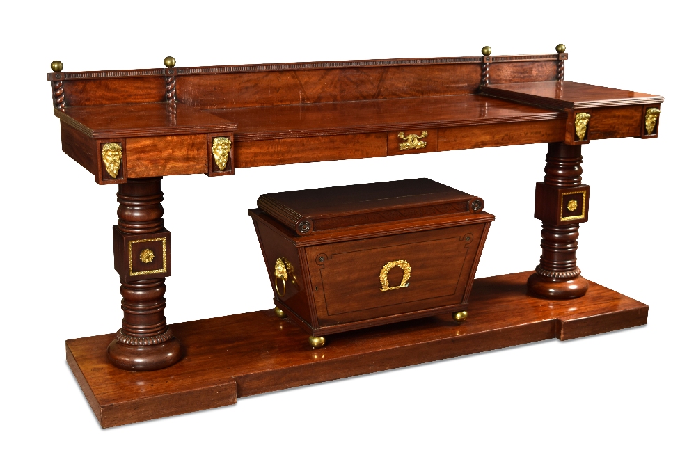 A 19th century mahogany serving table with integral wine cooler, with gilt mounts, raised back