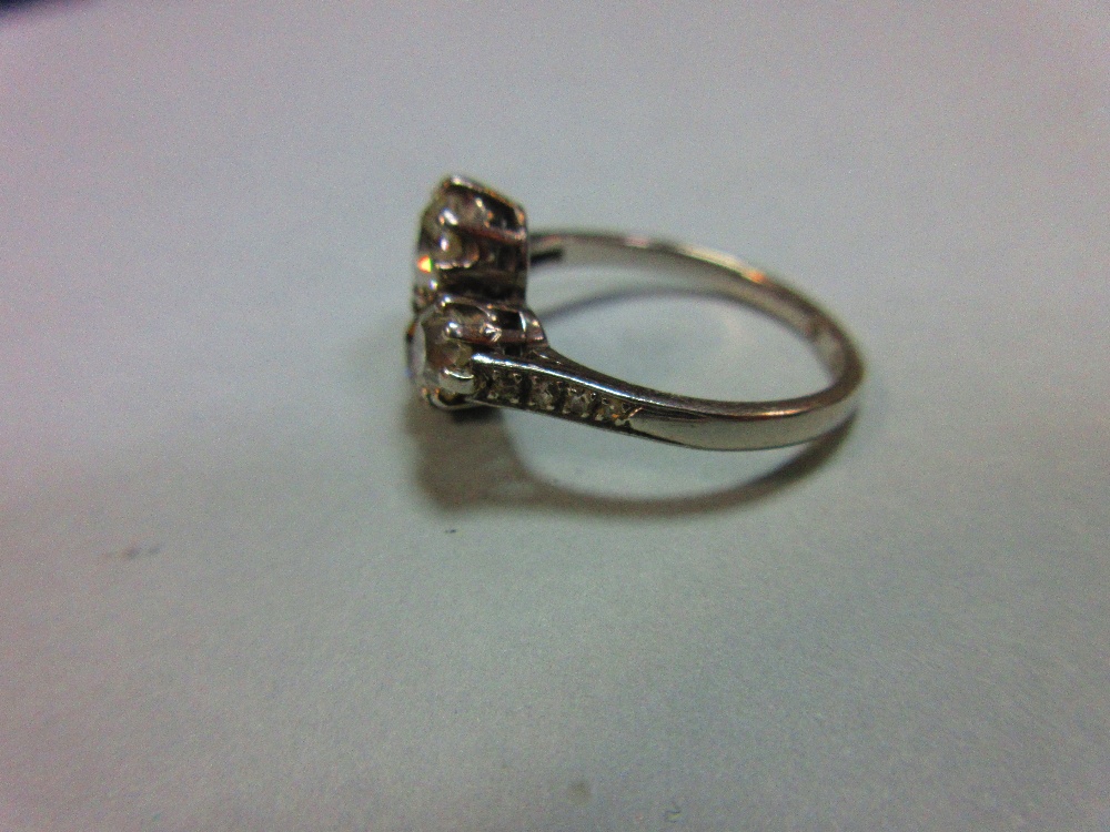 An unusual four stone diamond ring, the old round brilliant cut diamonds claw set in a horizontal - Image 3 of 7