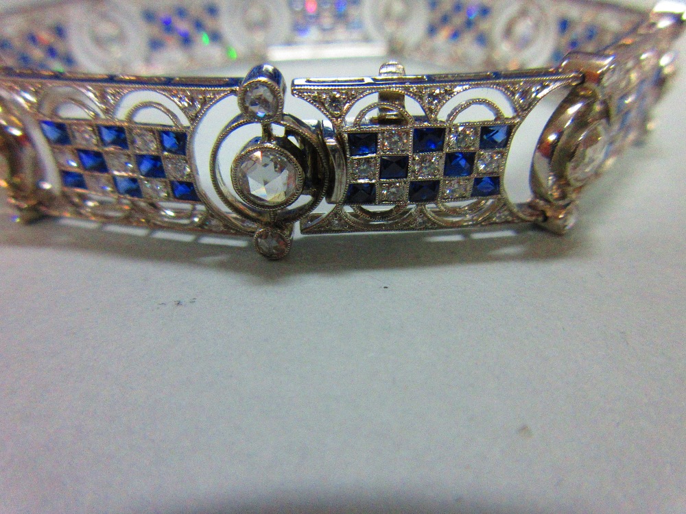 An art deco diamond and sapphire bracelet, designed as nine geometric pierced panels with a - Image 4 of 8