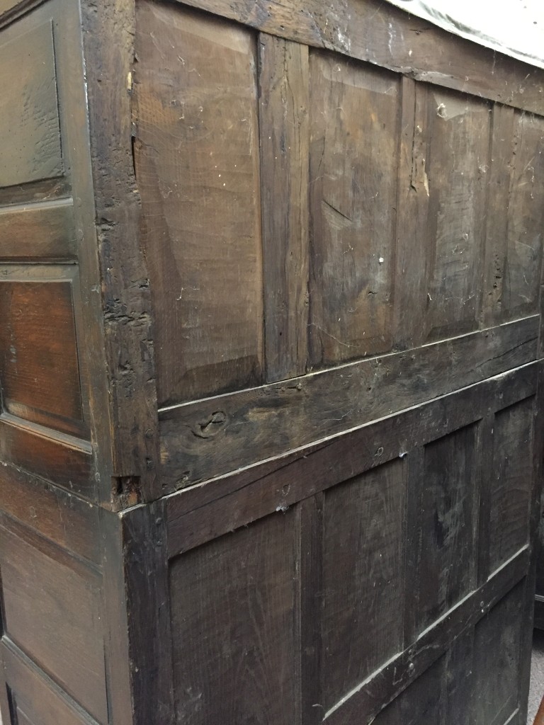 An 18th century oak panelled di-darne, with an over hung cornice and cupboards to the base, on stile - Image 2 of 4