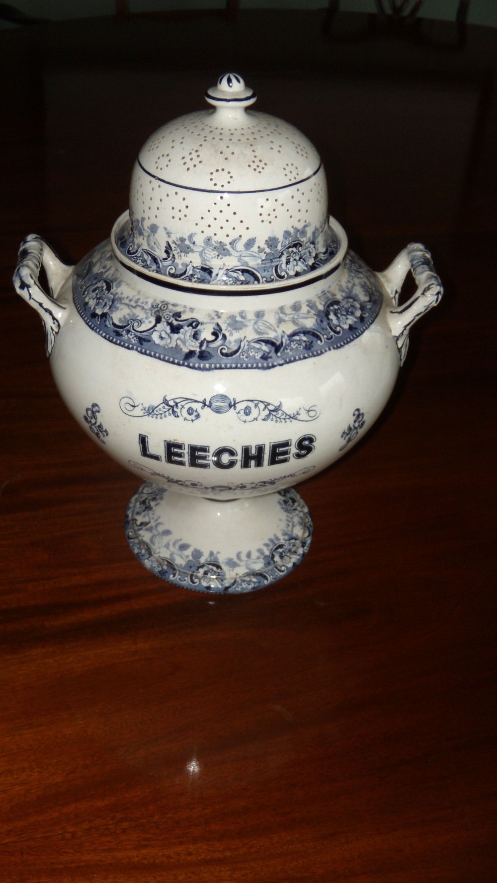 A 19th century blue and white pearlware 'Leeches' jar and pierced cover, the compressed spherical