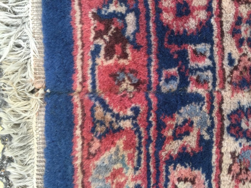 A Sparta blue ground carpet, decorated with branch and foliate designs within a dark pink border 597 - Image 4 of 9