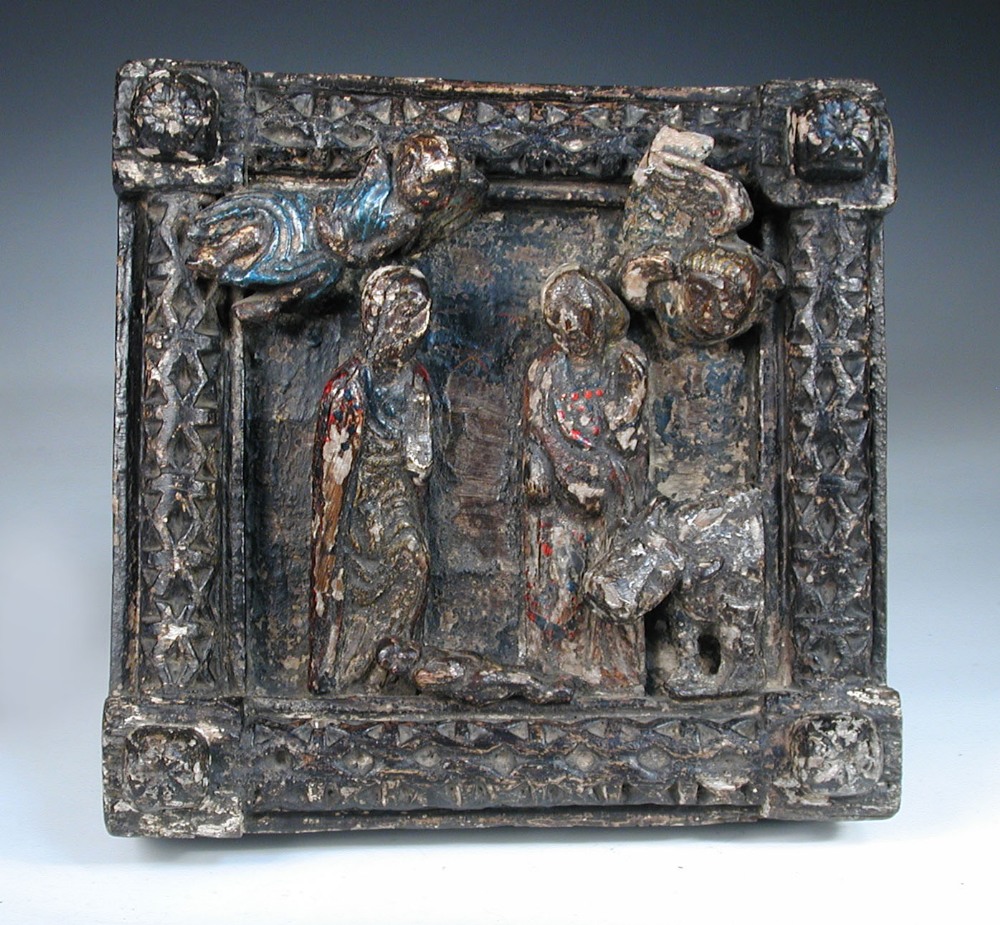 A 16th century Continental carved chestnut and polychrome decorated panel of the Nativity, the