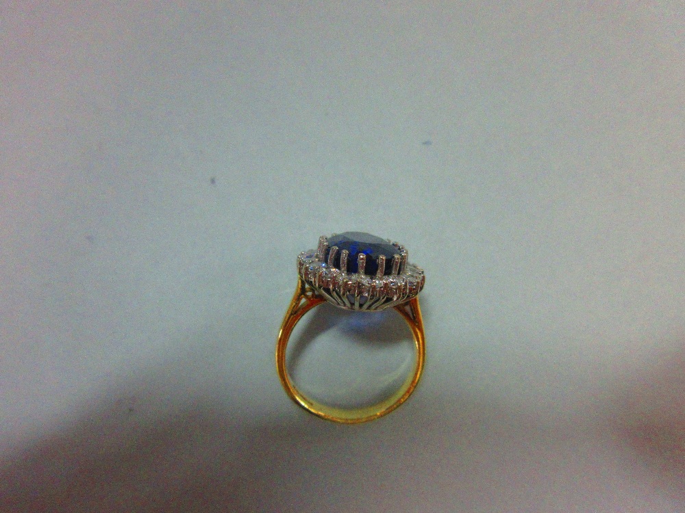 A large sapphire and diamond cluster ring, the oval cut deep blue sapphire, estimated weight 9. - Image 5 of 6