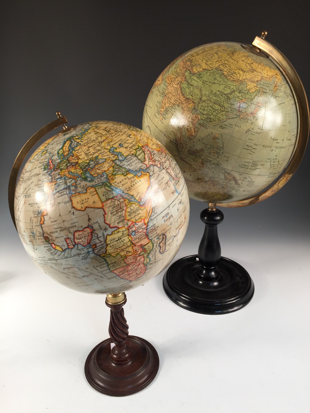 A Geographia 10 inch terrestrial globe, on a wrythen turned column stand, together with another 12