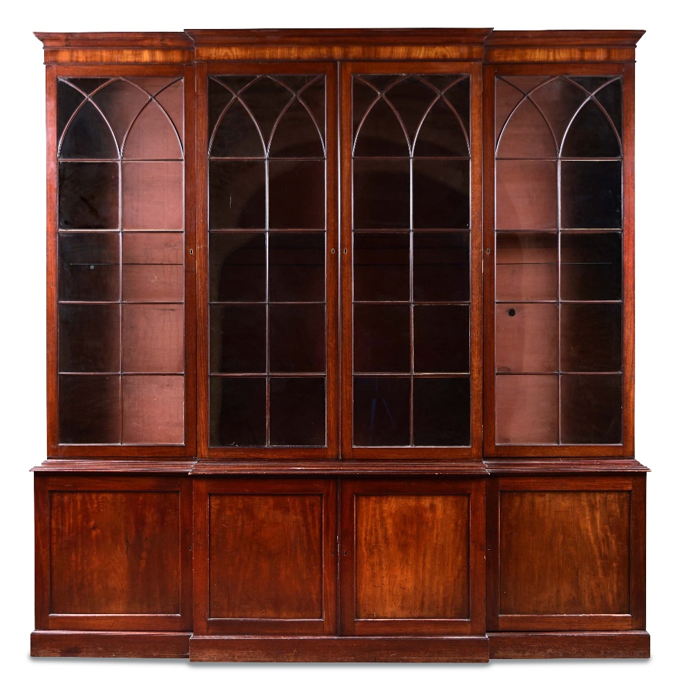 A George III mahogany breakfront library bookcase, with gothic arched glazed doors above and