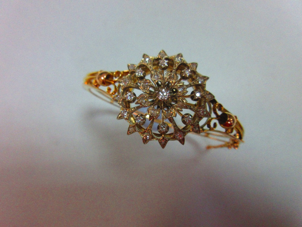 A Victorian diamond set hinged bangle / brooch, the bangle formed by knife-edge bars flaring at