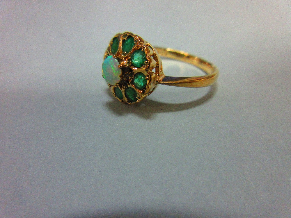 An opal and emerald cluster ring, with a round cabochon opal centre in a border of eight round cut - Image 2 of 4