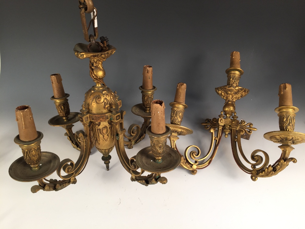 A late 19th/early 20th century bronze four branch ceiling light and matching wall light, each
