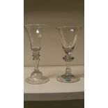 Two 18th century European wine glasses, each with hollow stems and on folded feet, one with bell