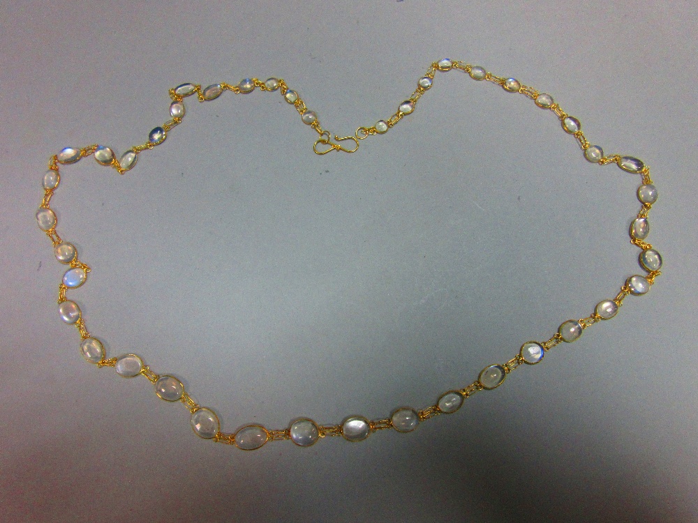 A moonstone necklace, designed as a chain of graduated spectacle set cabochon moonstones joined by - Image 3 of 4