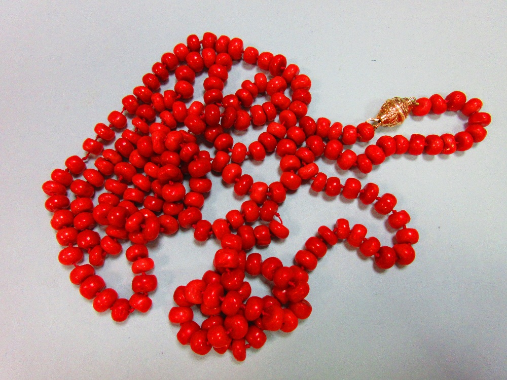 A long red coral bead necklace, the individually-knotted tyre shaped coral beads of approximately - Image 4 of 5
