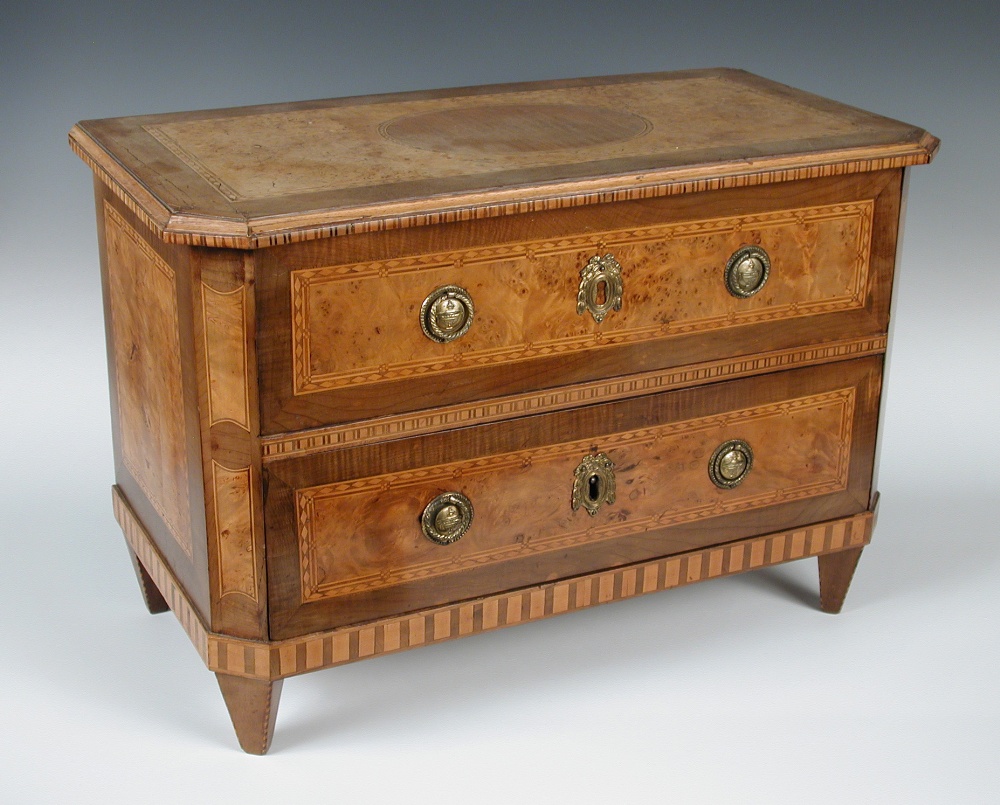 A 19th century Milanese miniature walnut marquetry commode, the rectangular top with canted front