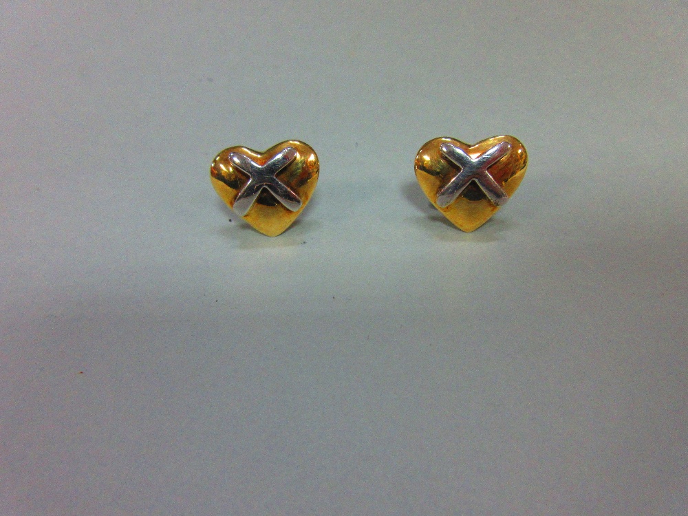 A pair of 9ct bi-colour gold hearts-and-kisses earstuds, each designed as a solid yellow gold