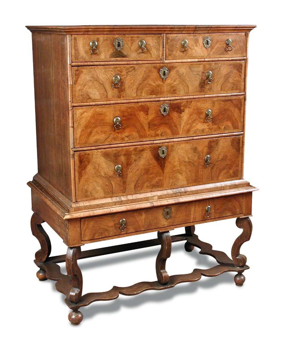 A William & Mary walnut chest on stand, with feather banded border decoration, brass drop handles,