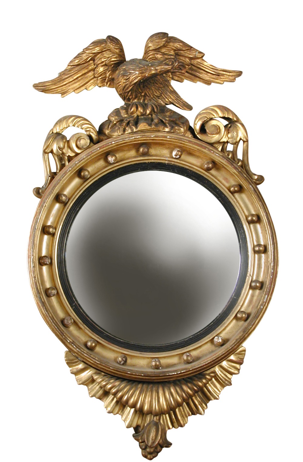 A Regency gilt framed convex mirror, with large eagle and scroll carved cresting, ball moulded frame