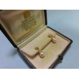 A pair of pearl and diamond earpendants cased by Garrard, each post headed by a 5mm pearl and