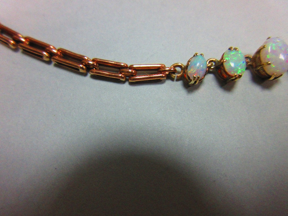 A graduated opal necklace, set to the front with an articulated line of eleven oval cabochon opals - Image 3 of 6