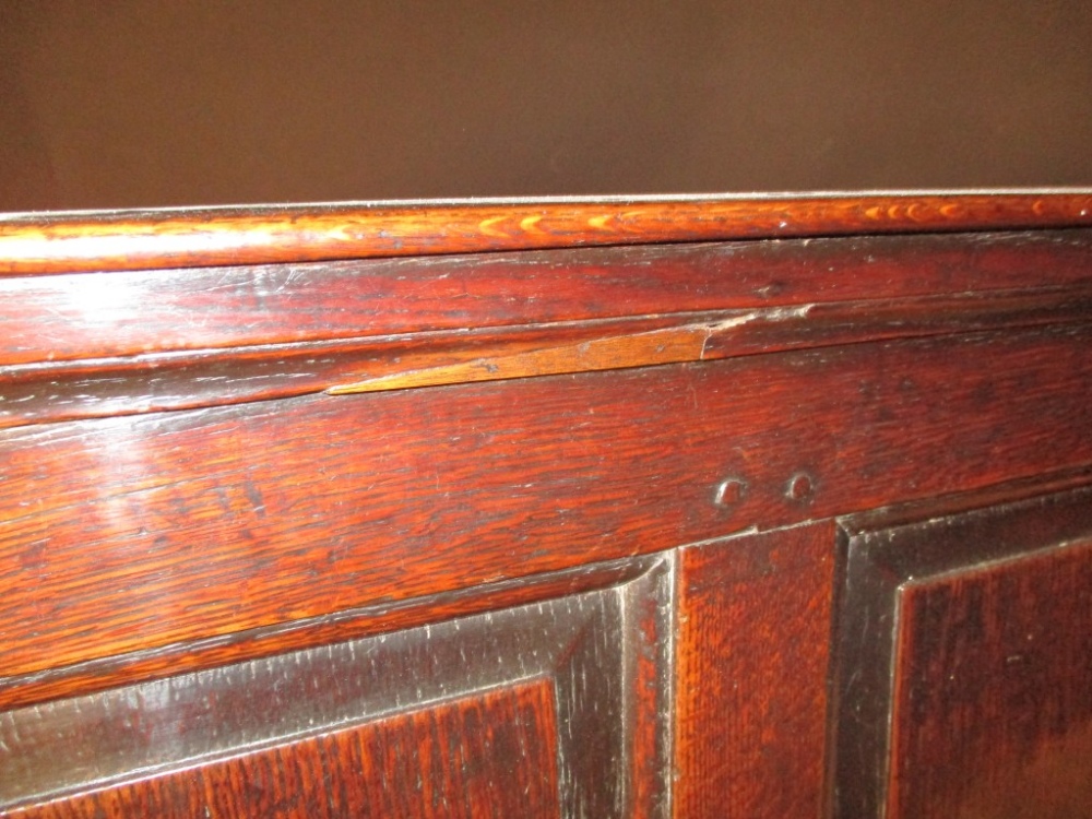 An early 18th century oak panelled settle, with open arms, strung seat and loose cushion, on - Image 4 of 4