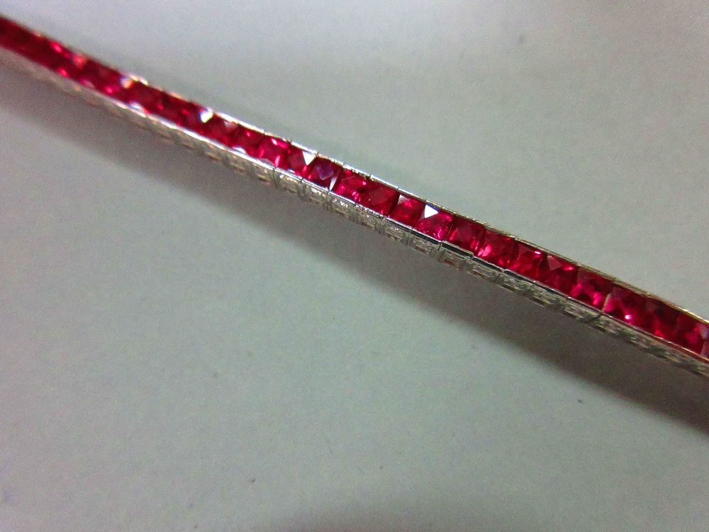 A ruby line bracelet, the square cut rubies channel set in a smooth continuous line of cubic