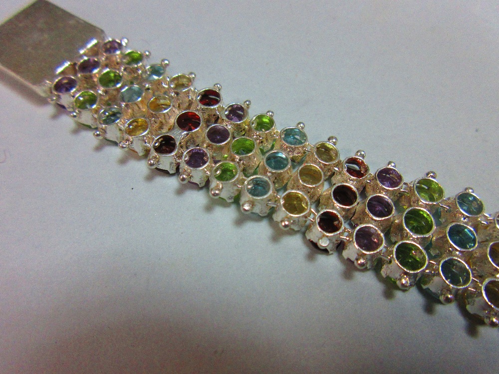 A multi gemset bracelet, composed of vertical lines of three round cut stones, alternating - Image 3 of 3