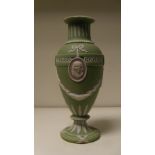 A Wedgwood three colour jasper vase, the green ovoid body with two classical profiles in white on