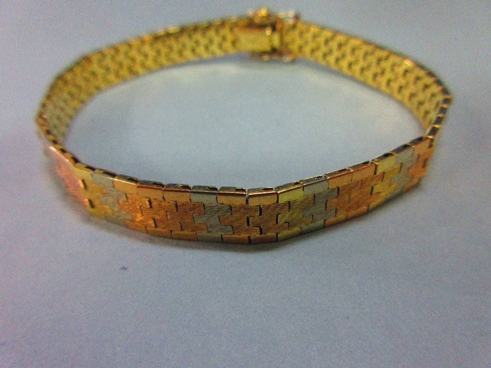 An Italian 18ct tri-coloured gold bracelet, the smooth ribbon of interlocking white, rose and yellow - Image 2 of 5