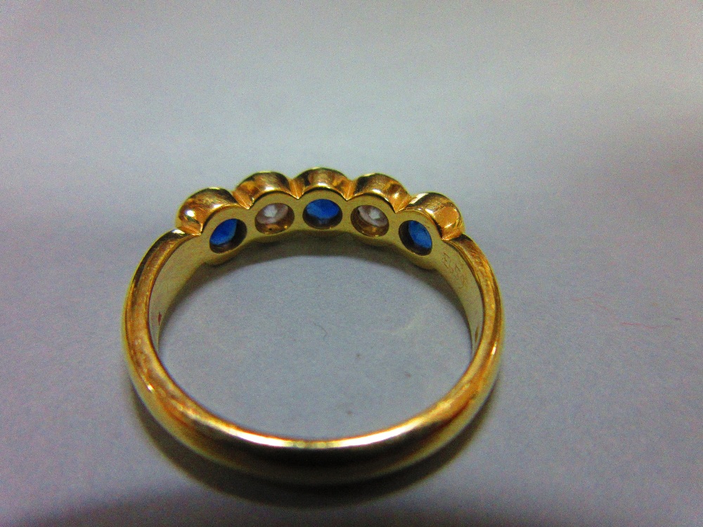 An 18ct gold, sapphire and diamond five stone ring, with two round brilliant cut diamonds spacing - Image 4 of 5