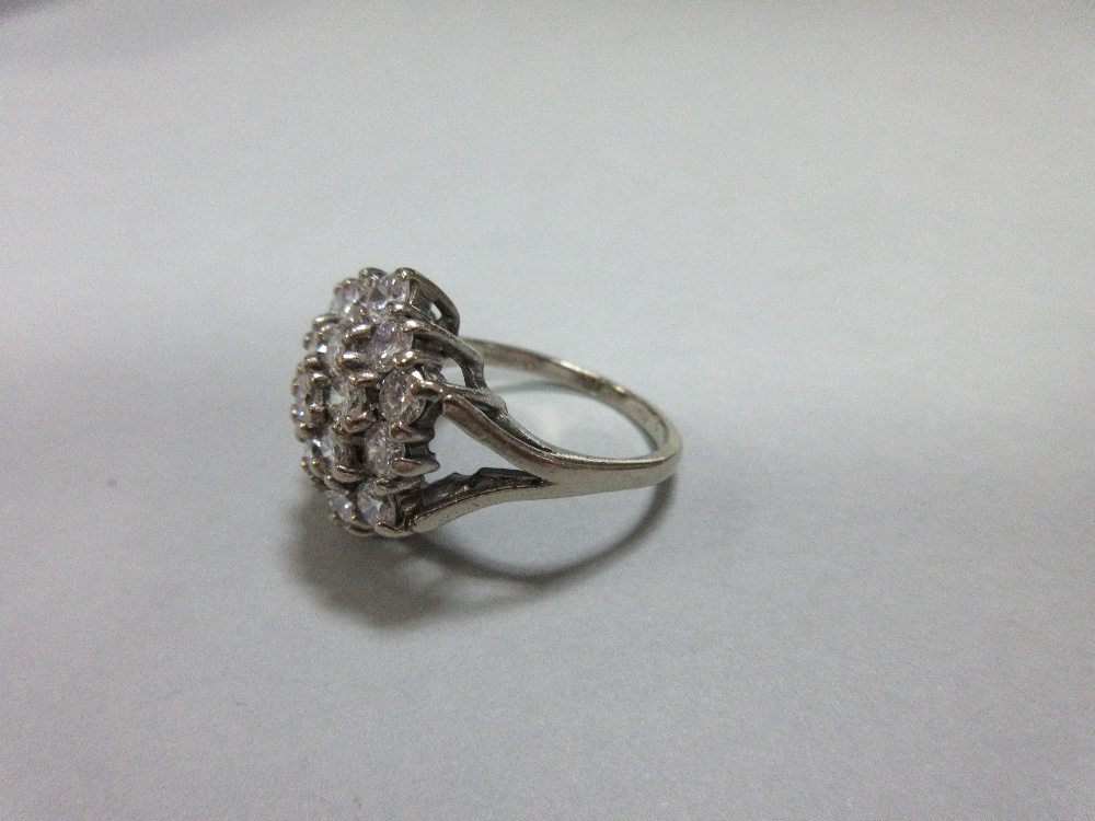 A diamond cluster ring set in 18ct gold, closely set with nineteen round brilliant cut diamonds in a - Image 2 of 6