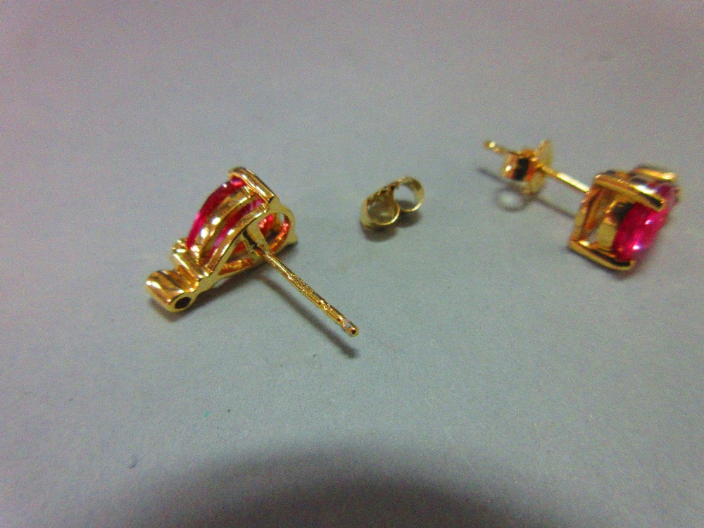 A pair of pink sapphire, diamond and 18ct gold earstuds, each post headed by a three claw set pear - Image 4 of 5