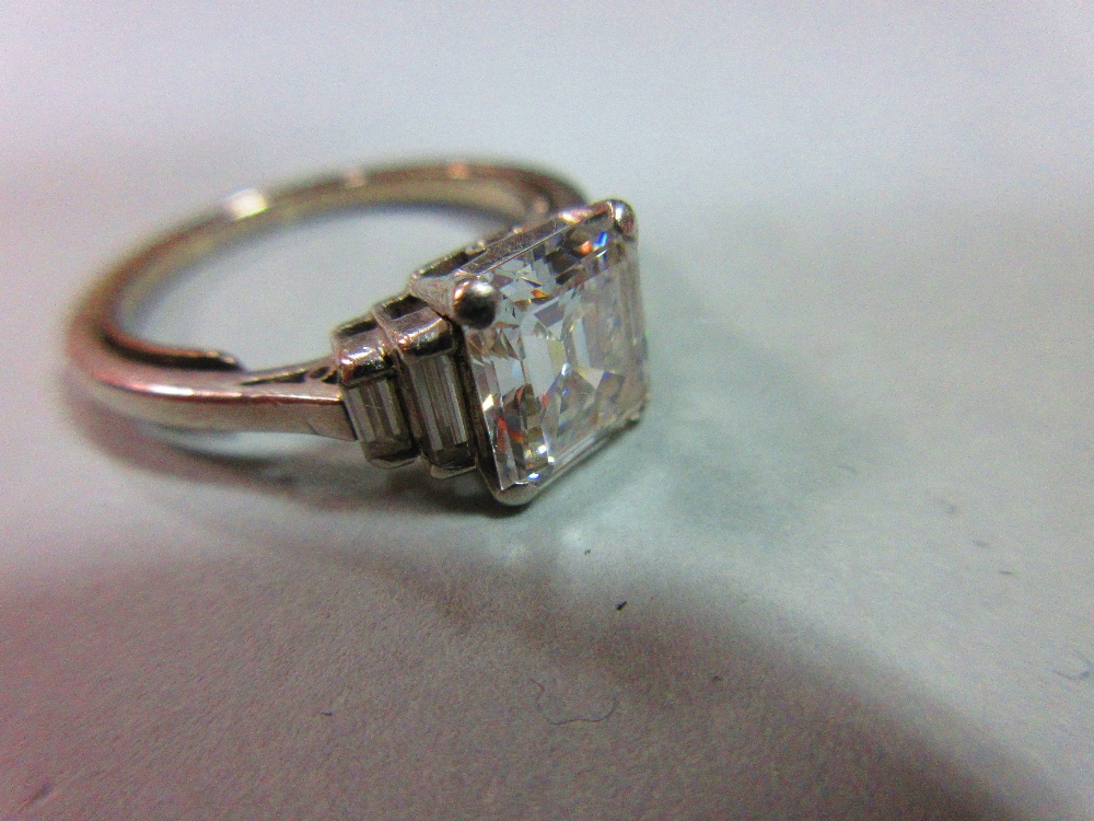 A diamond ring, the emerald cut principal stone, estimated weight 2.04cts, with two stepped baguette - Image 5 of 6