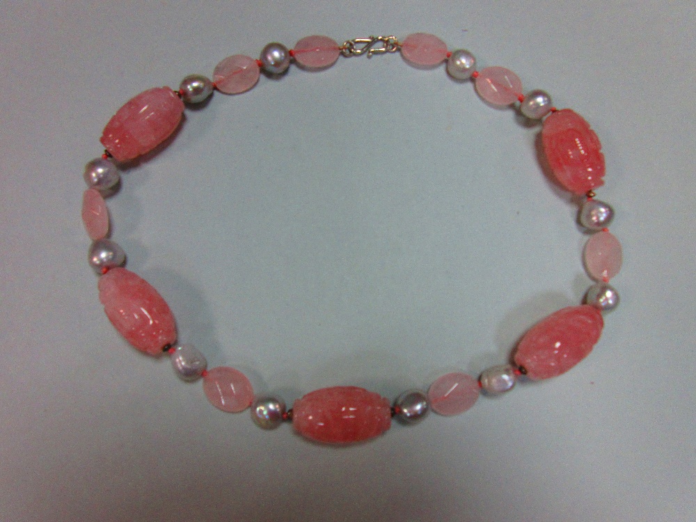 A carved rose quartz and pearl necklace, composed of five barrel shaped carved rose quartz beads