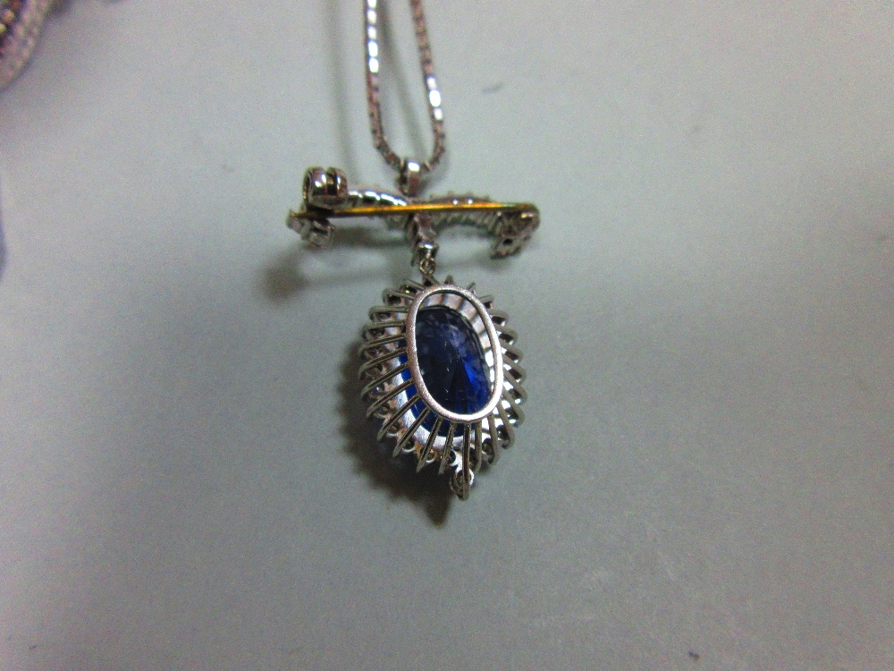 A sapphire and diamond pendant / brooch with white gold chain, the jewel designed as a large oval - Image 3 of 5