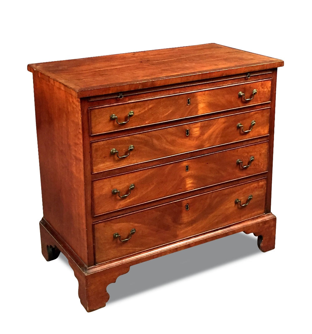 A George III mahogany chest of drawers, with chequered line inlaid decoration, brushing slide and