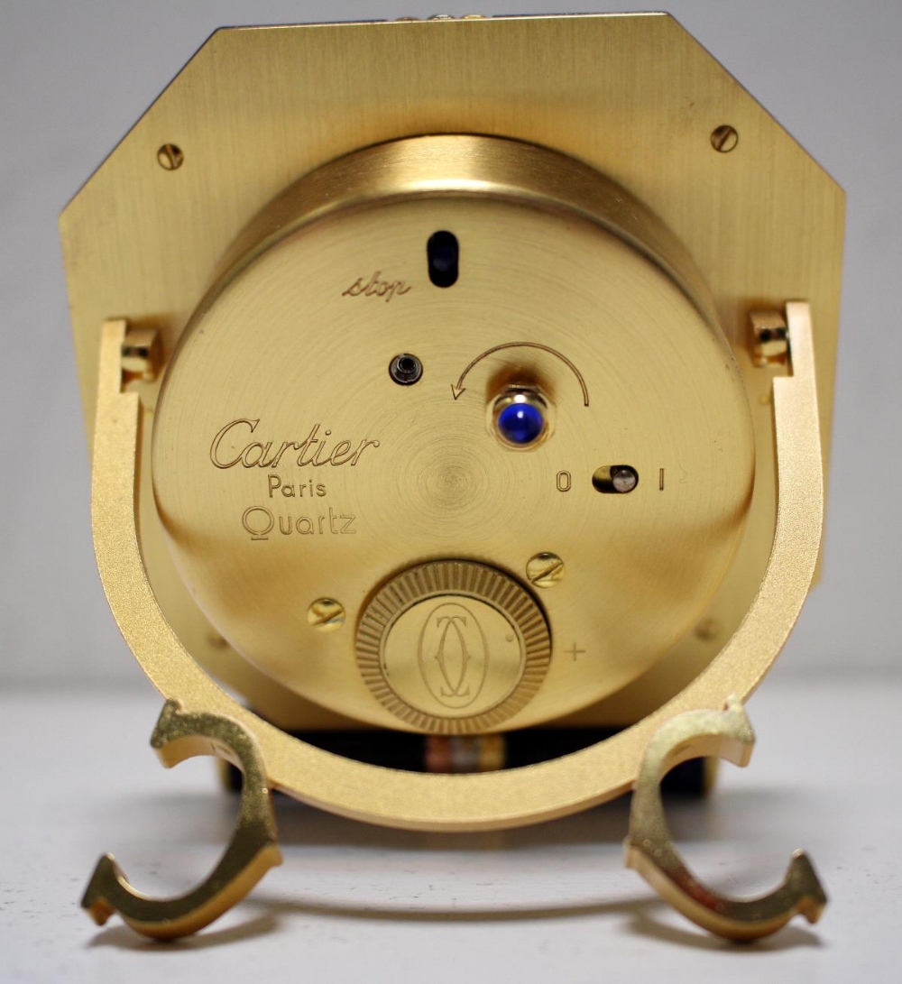 By Cartier - a brass cased travel alarm clock, with blue enamel and three tone gold plated octagonal - Image 4 of 4