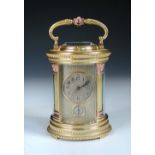 A French cylinder shaped gilt brass repeating carriage clock, circa 1900, the circular silvered dial