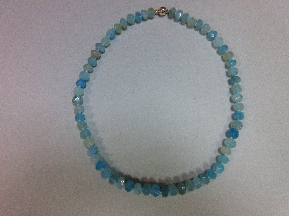 An aquamarine faceted bead necklace, the uniform 9mm faceted beads, individually knotted to a