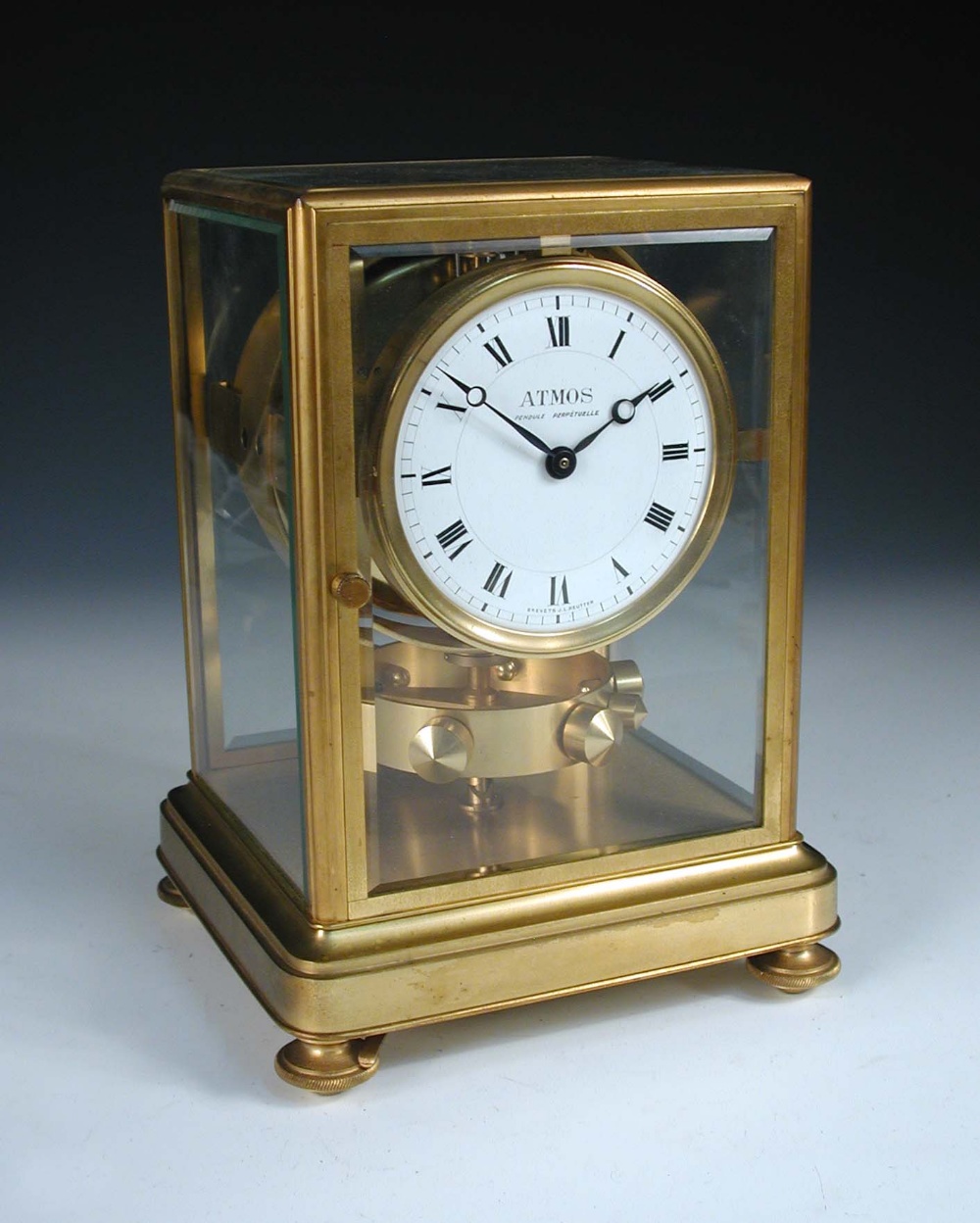 An early Atmos mantle clock by J. L. Reutter, serial no. 123, the bevelled glazed gilt frame case