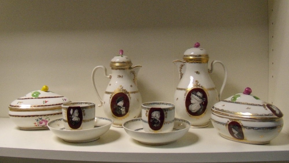 A late 18th/early 19th century Vienna porcelain part coffee service, each painted with grisaille