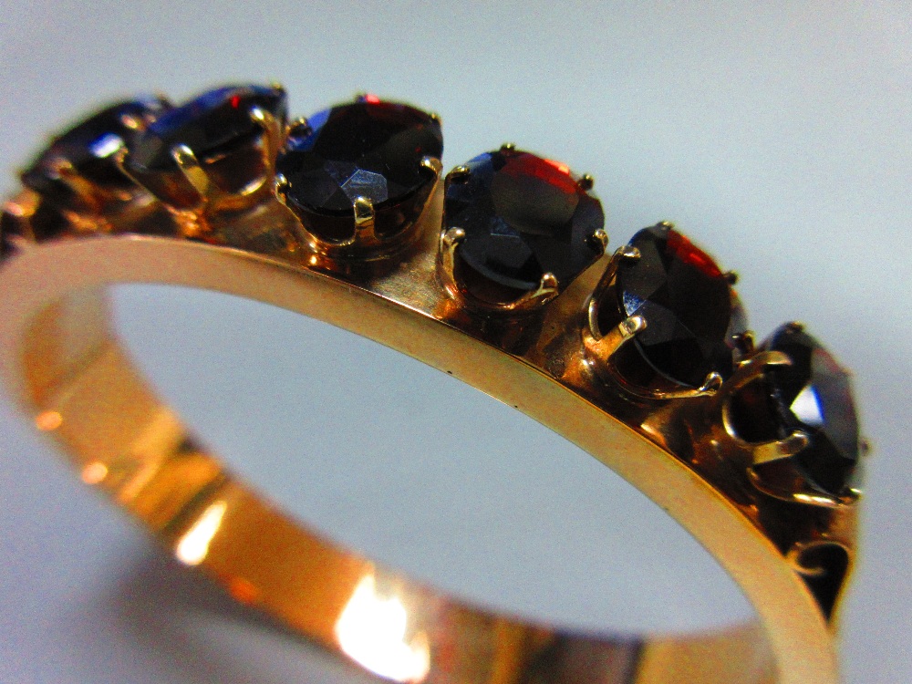 A 14ct gold and garnet hinged bangle, the polished gold hollow rectangular-section bangle, 9mm wide, - Image 3 of 3