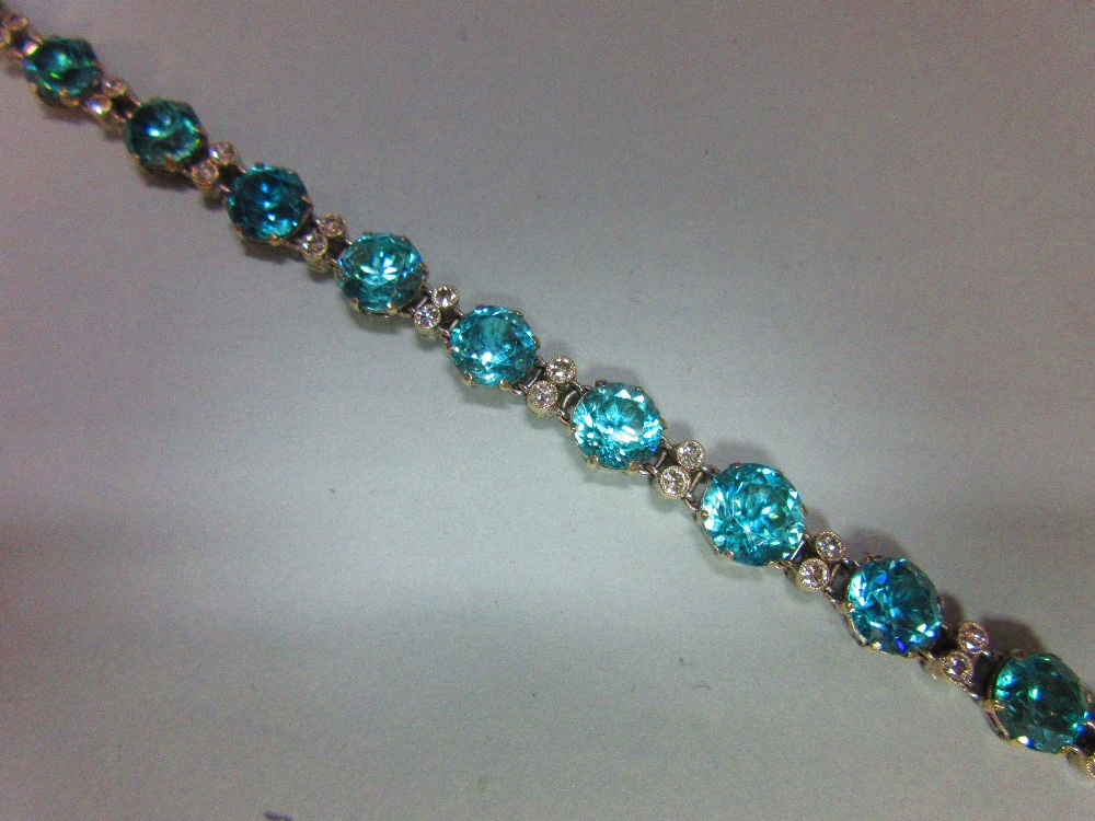 A blue zircon and diamond bracelet / necklace, composed of fifteen graduated round cut blue