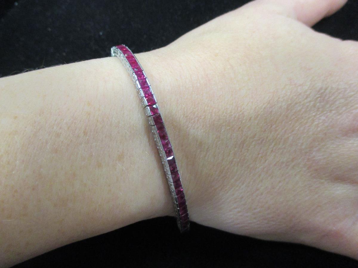 A ruby line bracelet, the square cut rubies channel set in a smooth continuous line of cubic - Image 2 of 2