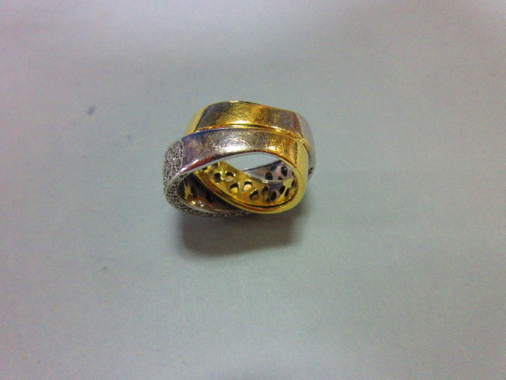 A modern diamond crossover band ring, of precious metal stamped '750' and designed as a plain - Image 6 of 6