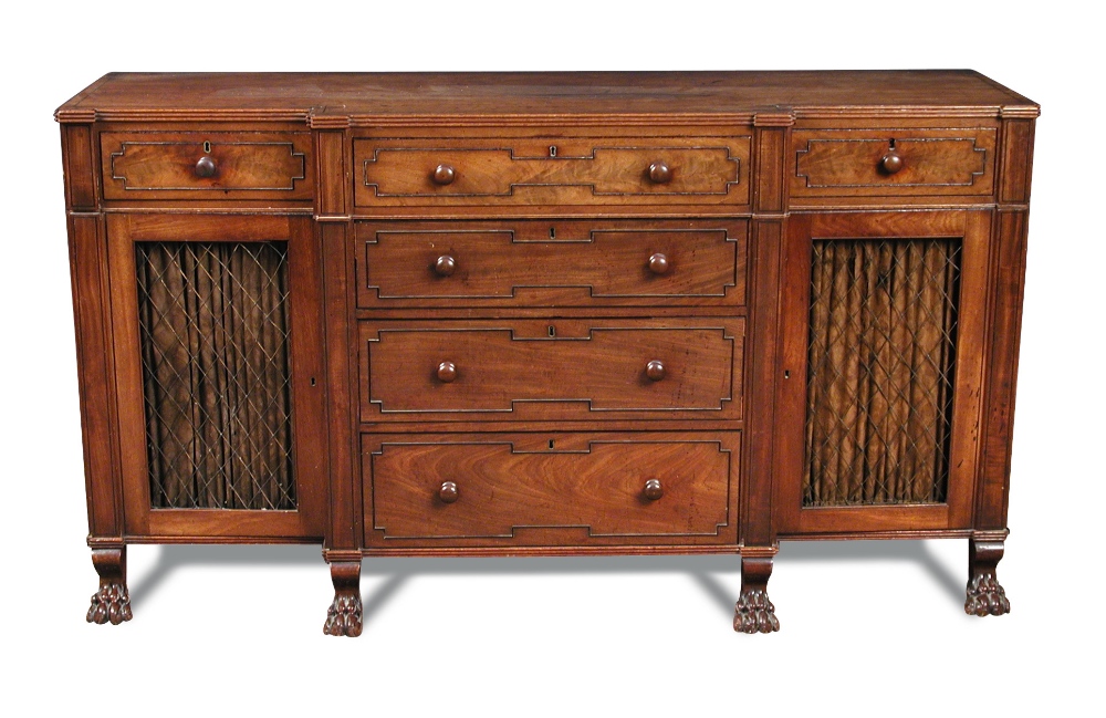 A Regency mahogany breakfront cabinet, fitted central drawers, ebony line border inlays and