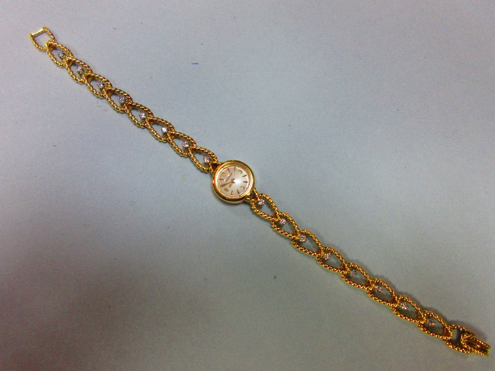 A Jaeger-LeCoultre lady's 18ct gold wristwatch with diamond set bracelet, the small circular cream