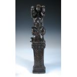 A 17th/18th century carved oak figural pilaster, modelled as Atlante, the waisted figure rising from